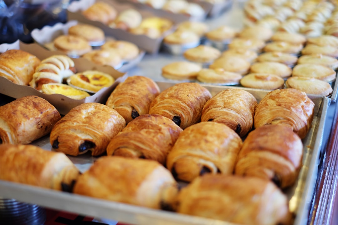 Trays of freshly baked croissants and pastries on display in a bakery