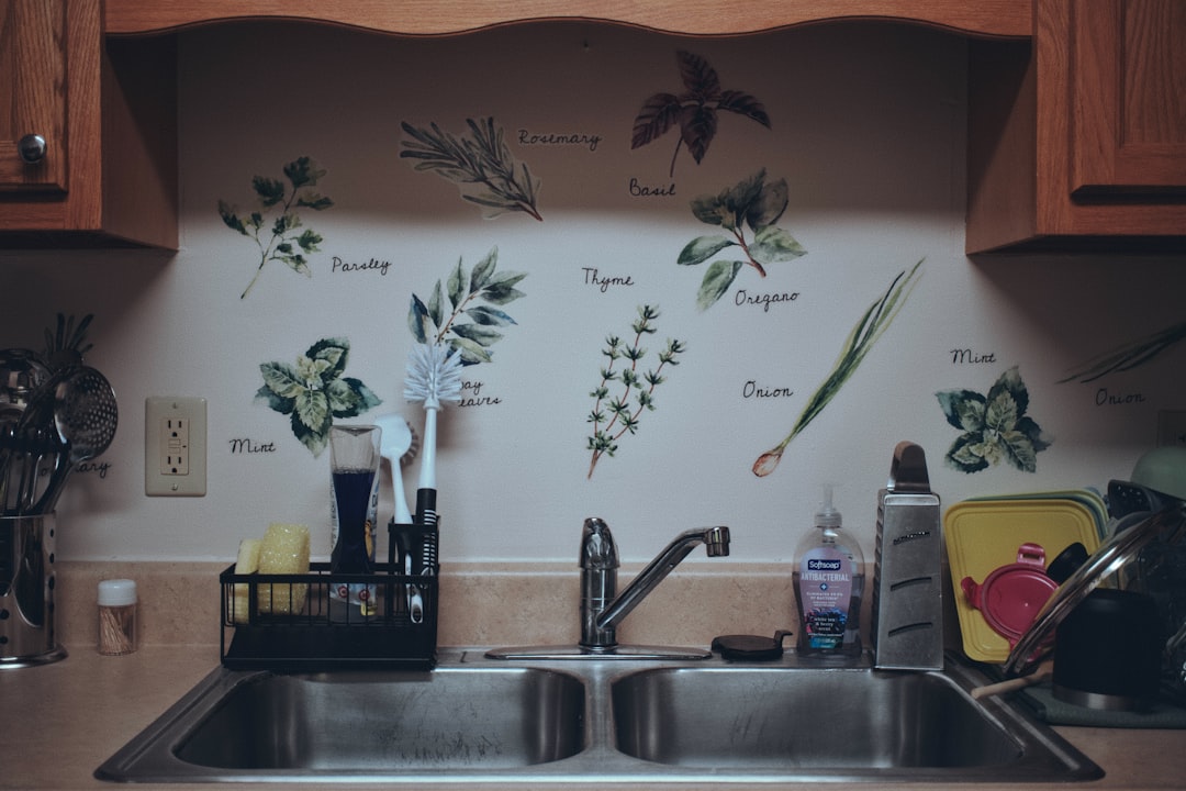 A kitchen sink with cleaning brushes, sponges, and dish soap
