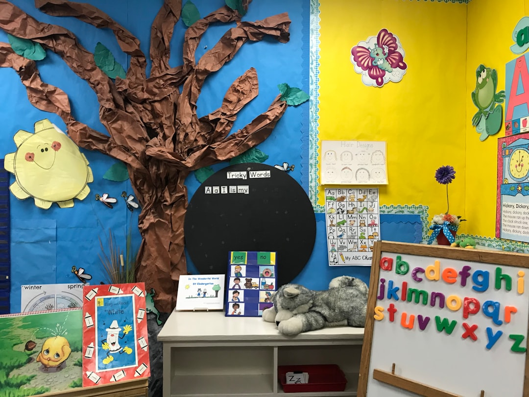 Colorful early childhood classroom with a decorative wall display, alphabet chart, and reading materials